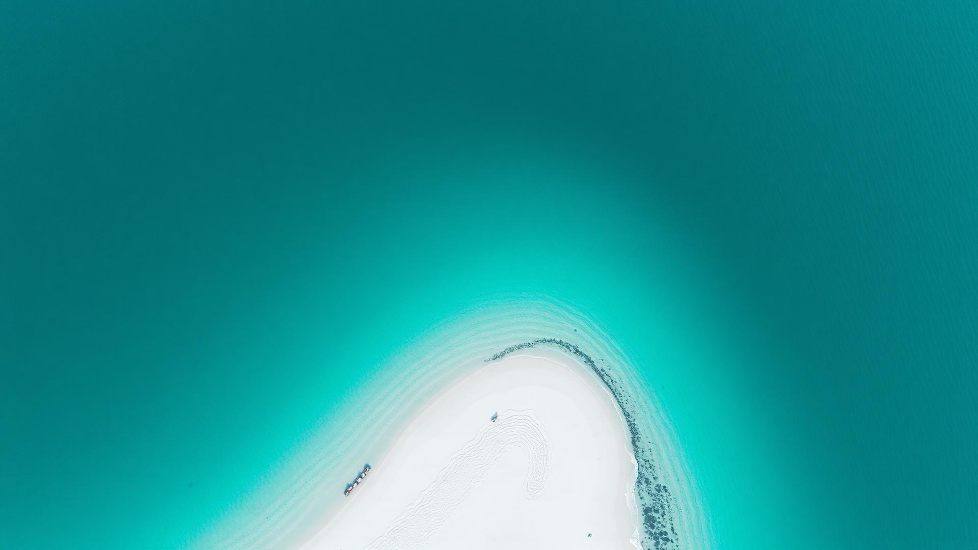 Aerial view of a turquoise tropical coastline